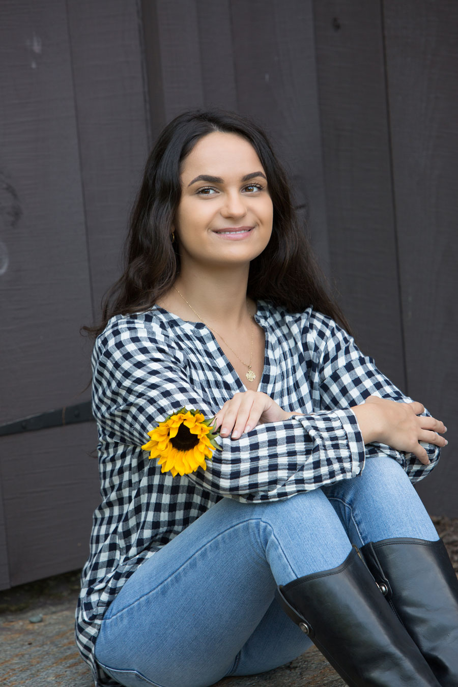 senior portrait of a girl holding sunflower